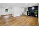 Open-concept living room features hardwood floors and a black fireplace at 466 Thackery Sw Pl, Atlanta, GA 30311