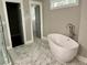 Bathroom with soaking tub, tiled floor, and neutral wall color at 1255 Plaza Sw Ave, Atlanta, GA 30310