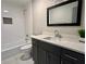 Bathroom with dark vanity, quartz countertop, and shower-tub combination at 1255 Plaza Sw Ave, Atlanta, GA 30310