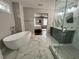 Primary bathroom with a glass-enclosed shower, soaking tub, and double vanity at 1255 Plaza Sw Ave, Atlanta, GA 30310