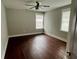 A well-lit bedroom with dark hardwood floors, two windows, and neutral walls provides a serene space at 1255 Plaza Sw Ave, Atlanta, GA 30310
