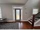 Bright foyer featuring hardwood floors, a modern staircase, and an elegant front door at 1255 Plaza Sw Ave, Atlanta, GA 30310