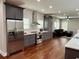 Modern kitchen featuring stainless steel appliances, gray cabinets, and an open design at 1255 Plaza Sw Ave, Atlanta, GA 30310