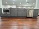 Kitchen gray cabinets, stainless steel appliances, and dark wood flooring at 1255 Plaza Sw Ave, Atlanta, GA 30310