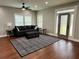Cozy living room showcasing hardwood floors, a ceiling fan, and stylish black furniture at 1255 Plaza Sw Ave, Atlanta, GA 30310