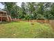 Expansive backyard with green grass, wooded views, and a new wooden fence at 1837 Lochlomand Se Ln, Smyrna, GA 30080