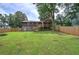 Large backyard with wooden privacy fence, grassy area, and deck at 1837 Lochlomand Se Ln, Smyrna, GA 30080