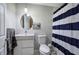 Bathroom featuring modern vanity, sleek mirror, and a shower with a striped curtain at 1837 Lochlomand Se Ln, Smyrna, GA 30080
