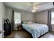 Bedroom with windows, ceiling fan, bedside table and light blue quilt at 1837 Lochlomand Se Ln, Smyrna, GA 30080