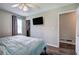 Bright bedroom with a ceiling fan, TV, walk-in closet, and neutral walls at 1837 Lochlomand Se Ln, Smyrna, GA 30080