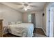 Cozy bedroom with wood-look floors, ceiling fan and comfortable bed at 1837 Lochlomand Se Ln, Smyrna, GA 30080