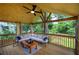 Comfortable covered deck with outdoor seating, ceiling fan, and green backyard views at 1837 Lochlomand Se Ln, Smyrna, GA 30080