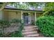 Cozy front porch with a welcoming entrance, adorned with a wreath, and decorative sconces at 1837 Lochlomand Se Ln, Smyrna, GA 30080