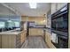 Modern kitchen with stainless steel appliances, built-in ovens, and wood cabinetry at 1837 Lochlomand Se Ln, Smyrna, GA 30080