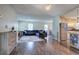 Open-concept living space showcasing a modern kitchen with island, dining area, and comfortable seating at 1837 Lochlomand Se Ln, Smyrna, GA 30080