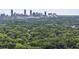 Gorgeous aerial view with lush green trees and skyline in distance, a serene setting for city living at 1864 Madrona Nw St, Atlanta, GA 30318