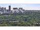 Breathtaking aerial view features vibrant green trees and skyline, highlighting the perfect blend of nature and city at 1864 Madrona Nw St, Atlanta, GA 30318