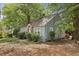 Side view of a light blue, single story home surrounded by lush greenery at 1864 Madrona Nw St, Atlanta, GA 30318