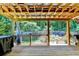 Wooden deck with an outdoor kitchen area, offering a peaceful view of the landscaped backyard and wooded surroundings at 4751 Shay Ter, Buford, GA 30519