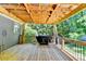 Large wooden deck with a grill, string lights, and a view of the wooded backyard, perfect for outdoor entertaining at 4751 Shay Ter, Buford, GA 30519
