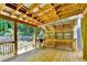 Charming deck area features an outdoor kitchen, string lights, and a scenic view of the tranquil backyard with pond at 4751 Shay Ter, Buford, GA 30519
