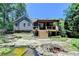 Charming backyard with a pond, lush greenery, deck, and stairs for outdoor enjoyment at 4751 Shay Ter, Buford, GA 30519