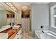 Well-lit bathroom featuring double sinks with wood countertop, modern fixtures, and a separate shower at 4751 Shay Ter, Buford, GA 30519