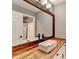 Modern bathroom featuring a unique wood-framed mirror, vessel sink, and stylish faucet, adding a touch of rustic charm at 4751 Shay Ter, Buford, GA 30519