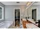 Bathroom showcasing double vanity with wood counter tops, modern faucets, and natural lighting at 4751 Shay Ter, Buford, GA 30519
