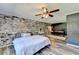 Bedroom featuring brick accent wall, ceiling fan, and wood floors at 4751 Shay Ter, Buford, GA 30519
