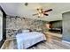 Bedroom featuring brick accent wall, ceiling fan, wood floors, and natural lighting at 4751 Shay Ter, Buford, GA 30519