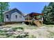 Exterior view of the home with a covered deck and well-maintained lawn at 4751 Shay Ter, Buford, GA 30519