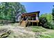 Exterior of the home features a covered deck, fenced yard, and mature trees at 4751 Shay Ter, Buford, GA 30519