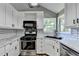 Modern kitchen with white cabinetry, stainless steel appliances, and a subway tile backsplash offering a clean and functional space at 4751 Shay Ter, Buford, GA 30519