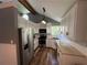 Well-lit kitchen features stainless steel appliances, stylish lighting, and abundant storage in white cabinets at 4751 Shay Ter, Buford, GA 30519