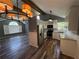 Modern kitchen with stainless steel appliances, white cabinets, and stylish wood-look floors open to living area at 4751 Shay Ter, Buford, GA 30519