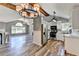 Open-concept kitchen and living area with vaulted ceilings, stainless steel appliances, and abundant natural light throughout at 4751 Shay Ter, Buford, GA 30519