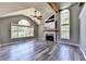 Bright living room with vaulted ceilings, a cozy fireplace, and large windows offering scenic views and new hard wood floors at 4751 Shay Ter, Buford, GA 30519