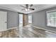 Relaxing main bedroom featuring ample natural light, a sliding barn door to the ensuite bathroom, and a serene, inviting ambiance at 4751 Shay Ter, Buford, GA 30519