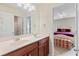 Bathroom featuring double sinks, granite counters, and access to hall bath at 3476 Bridge Walk Drive, Lawrenceville, GA 30044