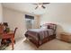 Bedroom featuring large window, desk, chair, full size bed, and overhead ceiling fan at 3476 Bridge Walk Drive, Lawrenceville, GA 30044