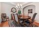 Elegant dining room with hardwood floors, chandelier, and ample seating at 3476 Bridge Walk Drive, Lawrenceville, GA 30044