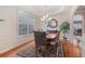 Formal dining room featuring hardwood floors, tray ceiling, and stylish light fixture at 3476 Bridge Walk Drive, Lawrenceville, GA 30044