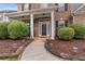 Inviting front entrance with a covered porch and manicured shrubbery at 3476 Bridge Walk Drive, Lawrenceville, GA 30044