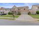 Charming brick home featuring an expansive driveway and well-maintained landscaping at 3476 Bridge Walk Drive, Lawrenceville, GA 30044