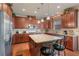 Traditional style kitchen features cherry wood cabinets, granite countertops, stainless steel appliances, and an island at 3476 Bridge Walk Drive, Lawrenceville, GA 30044