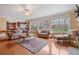 Open concept living room with plenty of natural light from large windows and comfortable seating at 3476 Bridge Walk Drive, Lawrenceville, GA 30044