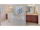 Bright main bathroom features a soaking tub, separate vanities, and tile flooring at 3476 Bridge Walk Drive, Lawrenceville, GA 30044