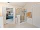Bright main bathroom featuring glass enclosed shower, tile floor, and access to main bedroom at 3476 Bridge Walk Drive, Lawrenceville, GA 30044