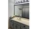 This bathroom features gray cabinets, a beige countertop, and a framed mirror at 5526 Stoneleigh Ct, Stone Mountain, GA 30088